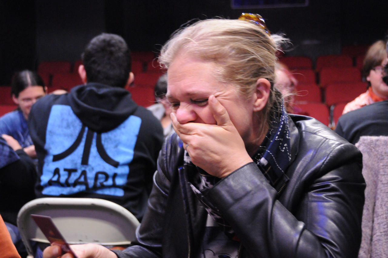 Carol Ziogas, one of the play-testers, cracking up as she reads an Exploding Kittens card.