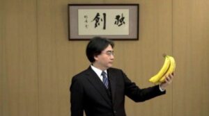 Iwata holds a bunch of bananas during a Nintendo Direct.