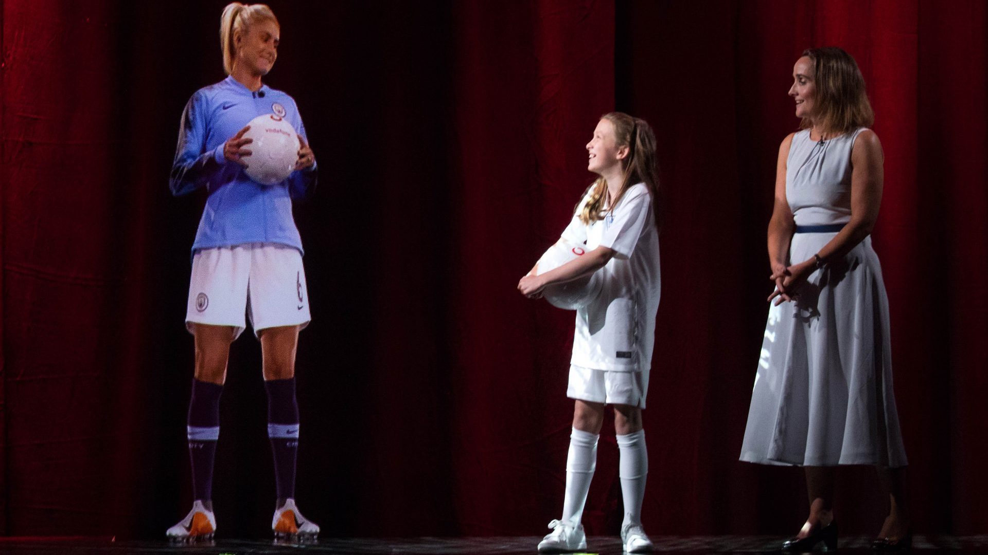 A holographic call using 5G enables a young soccer fan to meet and interact with a British soccer captain.