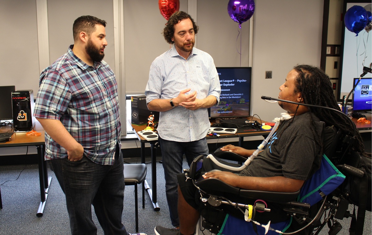 Mark Barlet, center, has received the Vanguard Award from Games for Change.