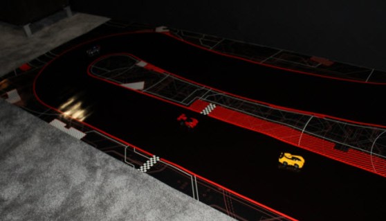Anki Drive AI car chases a human-driven car in a battle of wits.