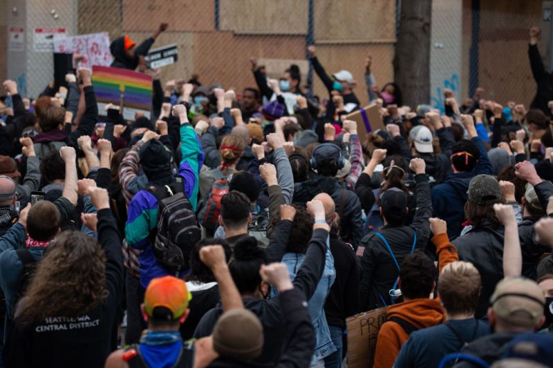 SEATTLE, WA - JUNE 08: Demonstrators hold a rally and teach-in outside of the Seattle Police Departments East Precinct, which has been boarded up and protected by fencing, on June 8, 2020 in Seattle, Washington. Seattle Police and Washington National Guard personnel vacated the area after the previous night saw violent clashes in the vicinity during ongoing Black Lives Matter protests in the wake of George Floyd's death.