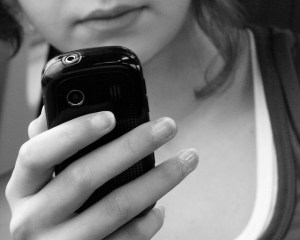 Girl playing a video game on a cellphone