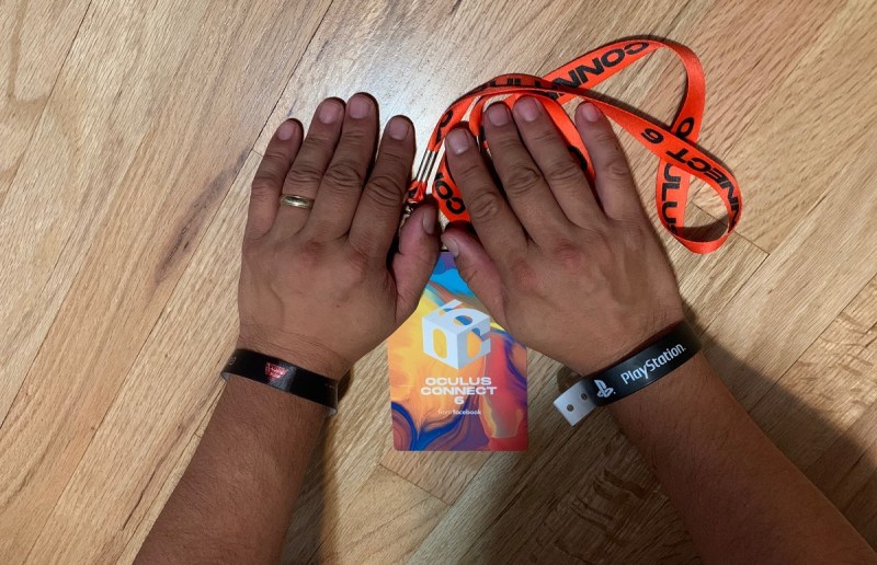 Dean's hands with a PlayStation wristband, a Lucasfilm wristband, and an OC6 badge.