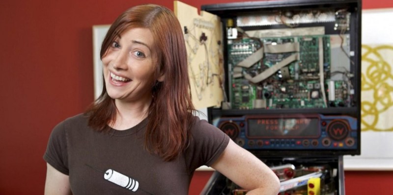 Tilt Five CEO Jeri Ellsworth in front of a pinball machine.