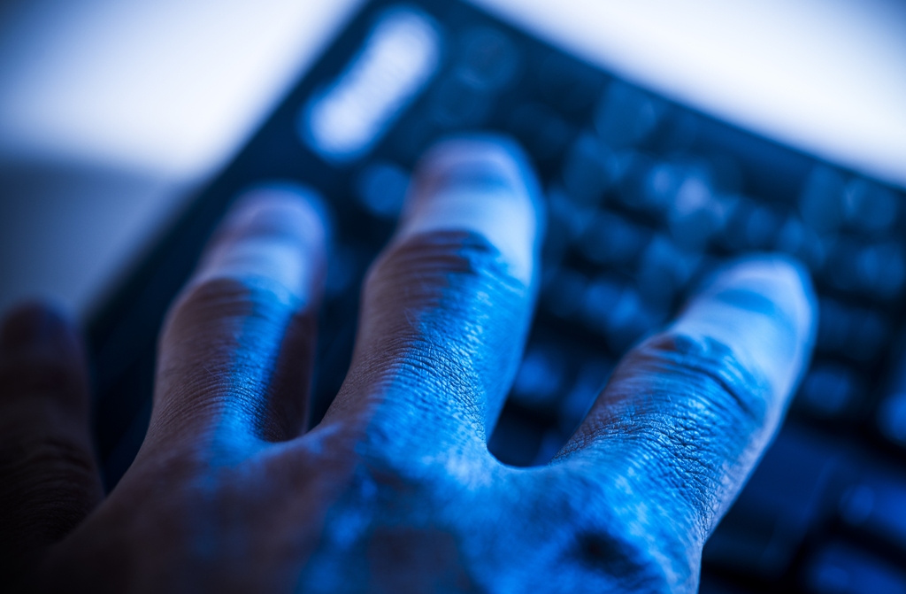 Image of person typing on a keyboard.