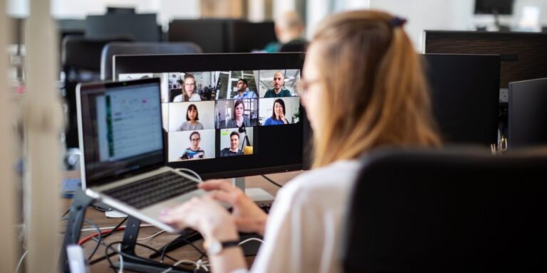 IT tech employee speaking with other employees in a Zoom meeting.