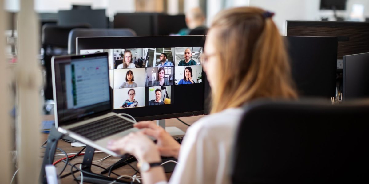 IT tech employee speaking with other employees in a Zoom meeting.