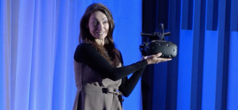 Intel's Sandra Rivera holds up a HTC Vive headset equipped with millimeter wave wireless technology.