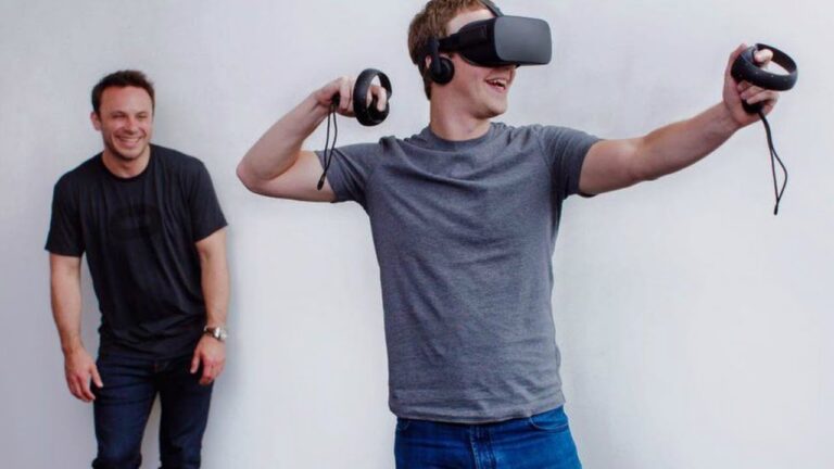 Mark Zuckerberg, Facebook CEO, in the Oculus Rift virtual reality headset as then-Oculus VR CEO Brendan Iribe looks on, in 2015.