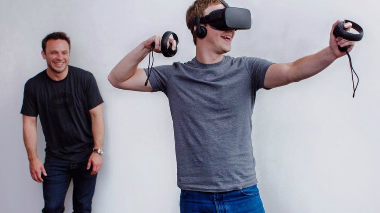 Mark Zuckerberg, Facebook CEO, in the Oculus Rift virtual reality headset as then-Oculus VR CEO Brendan Iribe looks on, in 2015.