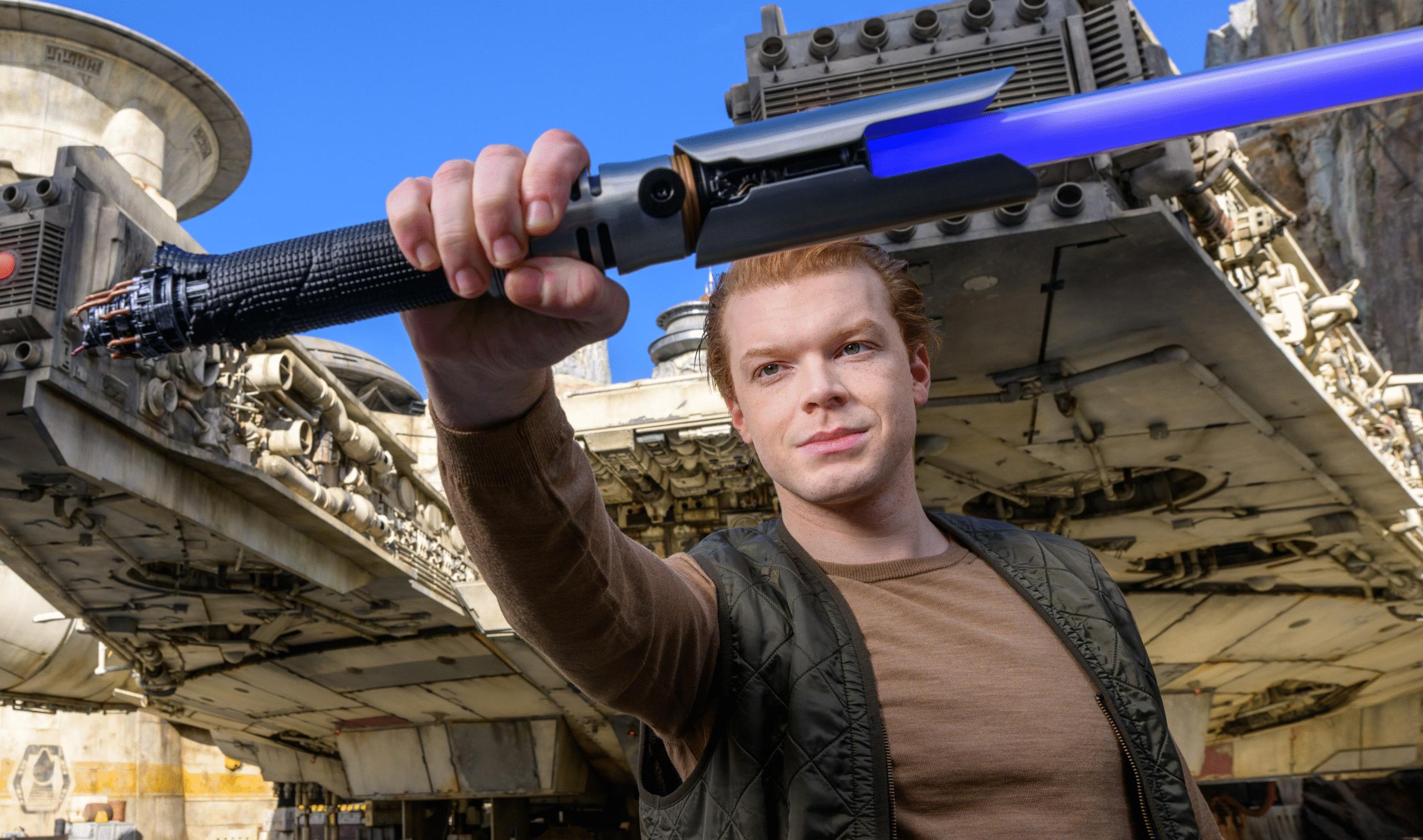Cameron Monaghan holding a replica of his character's lightsaber.