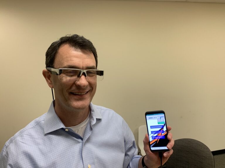 DigiLens CEO Chris Pickett shows off the DigiLens Crystal protoype AR glasses.