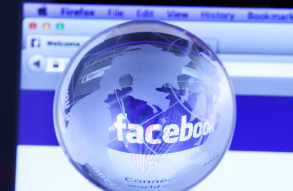 Facebook's webpage seen through a glass globe.