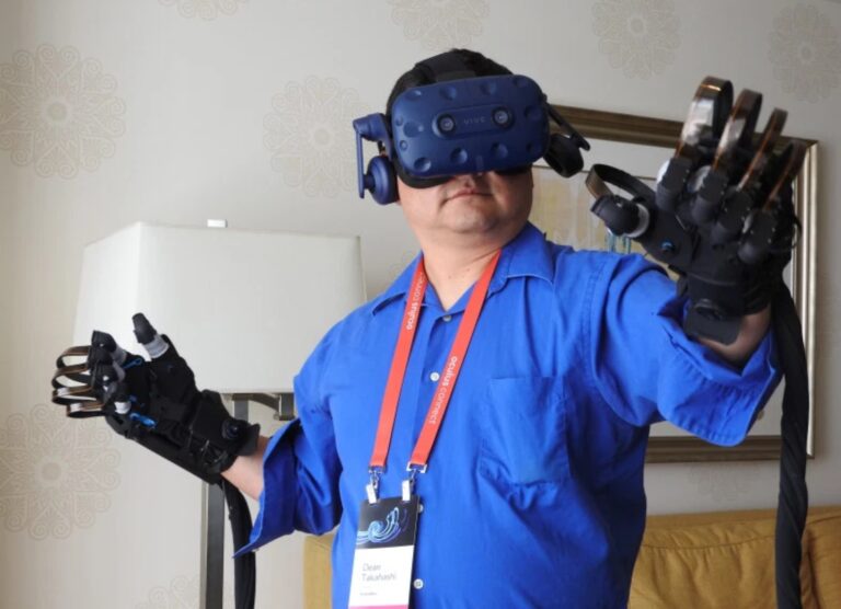 Dean Takahashi tries out the Haptx gloves with the HTC Vive VR headset.