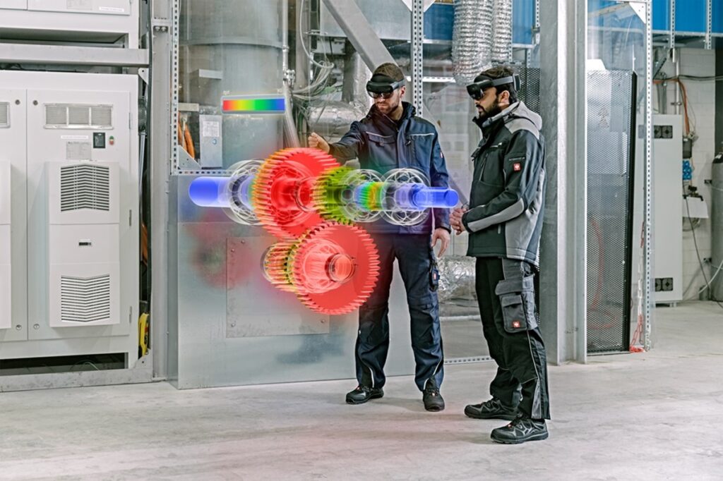 Workers use Hololight to study a turbine in a factory.