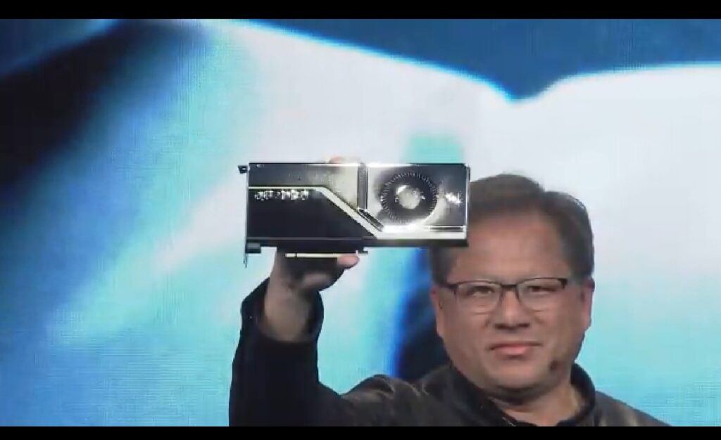 Jensen Huang shows off a Quadro RTX GPU.