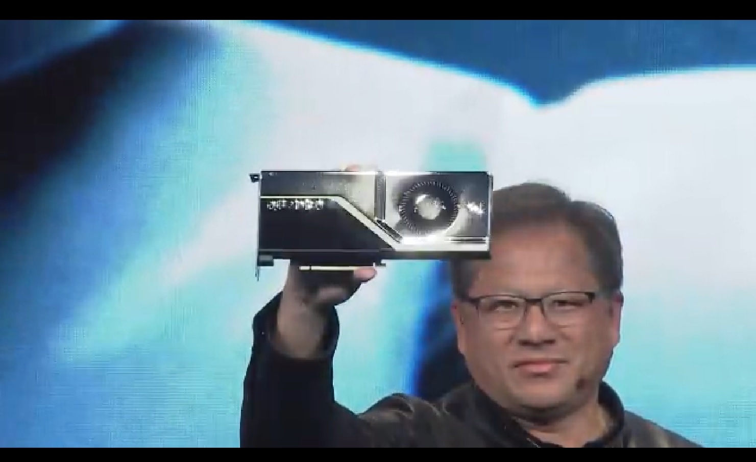 Jensen Huang shows off a Quadro RTX GPU.