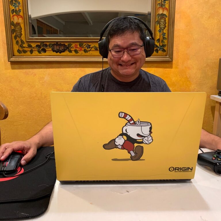 Dean Takahashi plays on a Origin PC laptop.