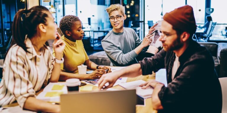 group of co-workers discussing a project in a boardroom