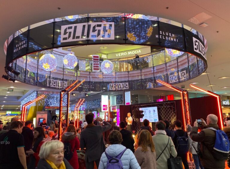 Slush talks on a side stage in a shopping mall.