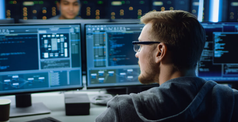 IT Specialist Working on Personal Computer with Monitors Showing Coding Language Program. Technical Room of Data Center. 1197071217