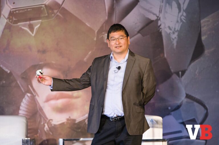 Dean Takahashi holds Cuphead at GamesBeat Summit 2018.
