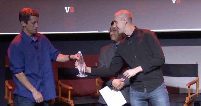 Spencer Tucker of Scopely gives the GamesBeat Visionary Award to Ted Price, CEO of Insomniac Games.