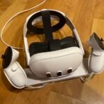 The Meta Quest 3 with Elite Strap on its charging dock.