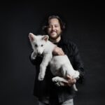 Ben Lamm holds one of the dire wolf pups.